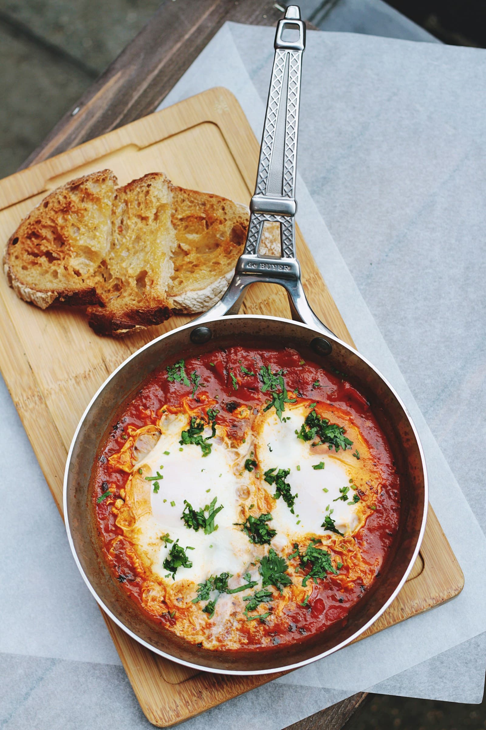 Photo of eggs in tomato sauce in a skillet