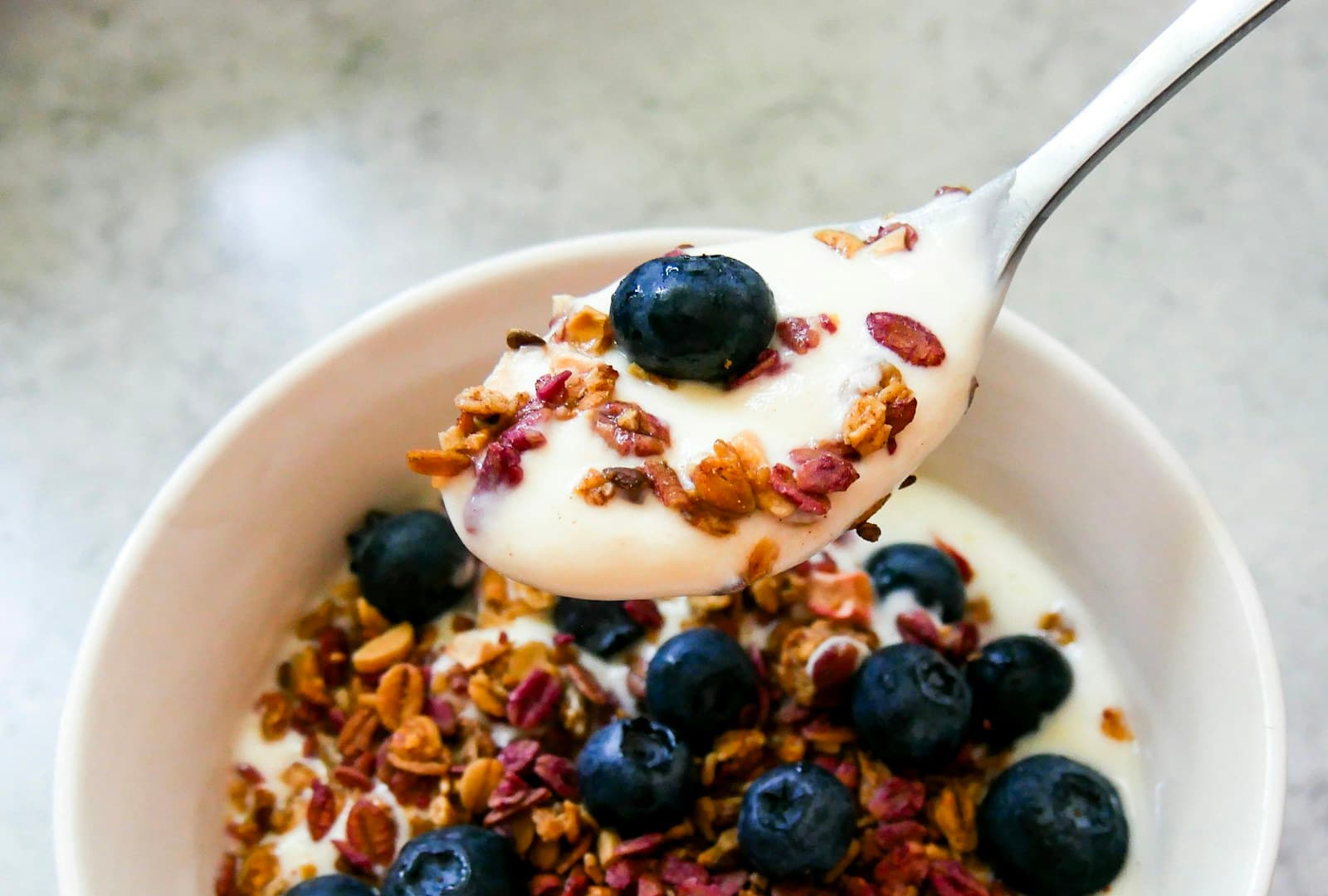 Photo of yogurt, blueberries, and crunchy oats in a bowl